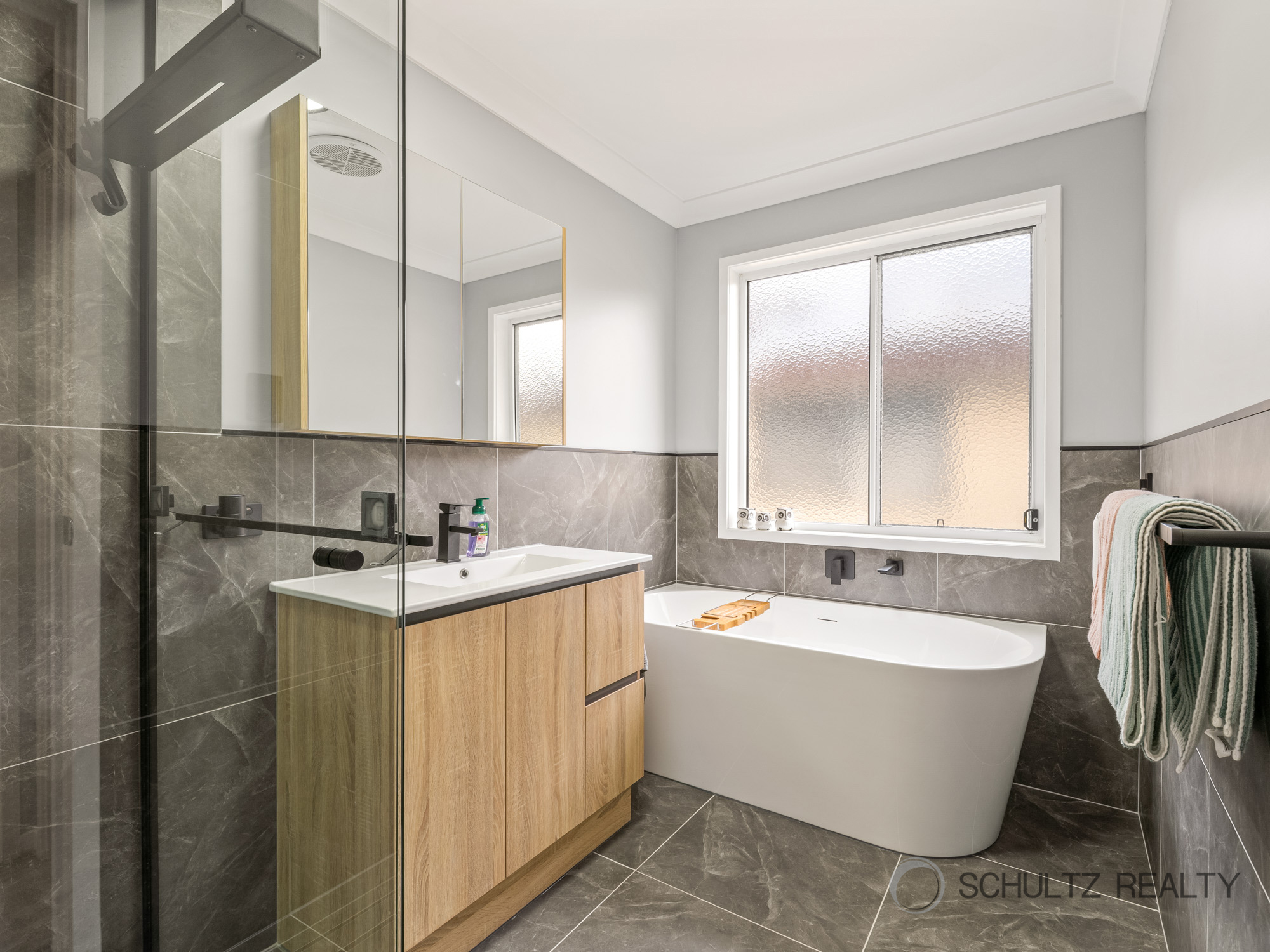 Modern bathroom renovation with wooden vanity